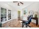 Office with decorative tile flooring, French doors, lots of natural light, and a modern ceiling fan at 7340 Brightwaters Ct, New Port Richey, FL 34652