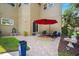 Charming patio with outdoor seating, a colorful rug, and a lush landscaped view from the backyard at 7340 Brightwaters Ct, New Port Richey, FL 34652