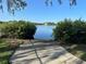 Water access with a boat ramp surrounded by lush greenery, providing a serene entrance to the calm water at 7340 Brightwaters Ct, New Port Richey, FL 34652