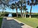 Water access with a boat ramp and palm trees on a clear day overlooking the calm water at 7340 Brightwaters Ct, New Port Richey, FL 34652