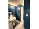 Bathroom featuring dark teal colored walls, vanity, mirror and lighting at 7534 Briarwood Dr, Port Richey, FL 34668