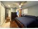 Bedroom featuring an ensuite bathroom, tile floors, and ceiling fan at 7534 Briarwood Dr, Port Richey, FL 34668
