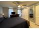 Bedroom featuring ceiling fan, closet, dresser and dark blue bedding at 7534 Briarwood Dr, Port Richey, FL 34668