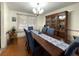 Dining room features a dark wood table with seating for six and wood laminate floors at 7534 Briarwood Dr, Port Richey, FL 34668