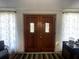 Inviting front entrance features hardwood floors and ornate double doors with decorative curtains at 7534 Briarwood Dr, Port Richey, FL 34668