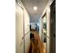 Hallway showcasing hardwood floors leading to a bathroom and living area at 7534 Briarwood Dr, Port Richey, FL 34668