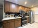 Kitchen features stainless appliances, sleek countertops, and wood cabinets with ample storage at 7534 Briarwood Dr, Port Richey, FL 34668