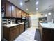 Bright kitchen features stainless appliances, wood cabinets, tile backsplash, and eat-in bar at 7534 Briarwood Dr, Port Richey, FL 34668