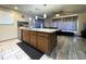 Kitchen island provides seating and view to living room and access to back yard at 7534 Briarwood Dr, Port Richey, FL 34668