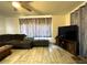 Cozy living room with tile floors, television, and sectional seating arrangement at 7534 Briarwood Dr, Port Richey, FL 34668