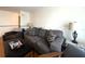 Comfortable living room featuring a gray sofa, patterned pillows, and a dark coffee table at 7534 Briarwood Dr, Port Richey, FL 34668