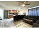 Open concept kitchen and living area featuring a breakfast bar and sectional couch at 7534 Briarwood Dr, Port Richey, FL 34668