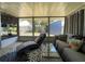 Relaxing sunroom with chaise lounge and a view of the backyard through large windows at 7534 Briarwood Dr, Port Richey, FL 34668
