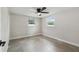 Bedroom with neutral walls, tile floors, and ceiling fan with light at 7545 Banner St, New Port Richey, FL 34653
