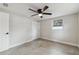 Neutral bedroom featuring modern ceiling fan, large closet and window at 7545 Banner St, New Port Richey, FL 34653