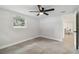 Bedroom with tile floors, a window, and view into the kitchen at 7545 Banner St, New Port Richey, FL 34653