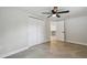Bedroom features tile floors, ceiling fan, and closet; doorway shows kitchen at 7545 Banner St, New Port Richey, FL 34653