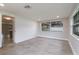 Bright bonus room with shiplap wall and tile floors; waiting for its new Gathering! at 7545 Banner St, New Port Richey, FL 34653