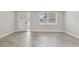 Entryway with neutral walls, new floor, large front door, and a large window at 7545 Banner St, New Port Richey, FL 34653
