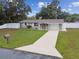 Charming single-Gathering home featuring a well-manicured lawn and a classic driveway at 7545 Banner St, New Port Richey, FL 34653
