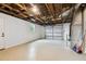 View of a garage interior with epoxy floors and open ceiling at 7545 Banner St, New Port Richey, FL 34653