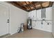Garage with epoxy floors, white walls, water heater, and electrical panel at 7545 Banner St, New Port Richey, FL 34653