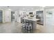 Modern eat-in kitchen with white cabinets, stainless steel appliances, a large island, and barstool seating at 7545 Banner St, New Port Richey, FL 34653