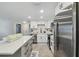 Bright kitchen with a large island, white cabinets, and stainless steel appliances at 7545 Banner St, New Port Richey, FL 34653