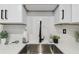 A stainless steel sink with quartz countertops, white cabinets, and a modern black faucet at 7545 Banner St, New Port Richey, FL 34653