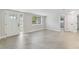 Bright living room with new tile flooring and a front door with glass panel at 7545 Banner St, New Port Richey, FL 34653