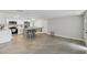 Open living room and kitchen with tile floors and white cabinetry at 7545 Banner St, New Port Richey, FL 34653