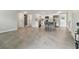 Open living room and kitchen with tile floors and white cabinetry at 7545 Banner St, New Port Richey, FL 34653