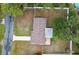 Aerial view of the backyard featuring a patio, mature trees, and privacy fencing at 7545 Banner St, New Port Richey, FL 34653