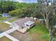 Backyard with fenced yard, patio, mature tree, and lush landscape at 7545 Banner St, New Port Richey, FL 34653