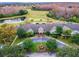 Scenic aerial view of the community clubhouse, golf course, and surrounding landscape at 8149 Ambersweet Pl, Land O Lakes, FL 34637