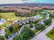 Aerial view of golf course and club house with inviting pool and green space in a friendly community at 8149 Ambersweet Pl, Land O Lakes, FL 34637