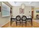 Well-lit dining room features wood floors, modern chandelier, and comfortable seating at 8149 Ambersweet Pl, Land O Lakes, FL 34637