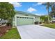 Attractive single-level home with a two-car garage and lush green landscaping at 8149 Ambersweet Pl, Land O Lakes, FL 34637