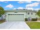 Charming single-story home with a manicured lawn and attached two-car garage at 8149 Ambersweet Pl, Land O Lakes, FL 34637