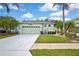 Beautiful one-story home featuring a well-maintained lawn and freshly painted driveway at 8149 Ambersweet Pl, Land O Lakes, FL 34637