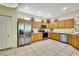 Spacious kitchen featuring stainless steel appliances and plenty of wood cabinetry at 8149 Ambersweet Pl, Land O Lakes, FL 34637