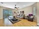 Bright living room featuring hardwood floors, a ceiling fan, and a sliding glass door at 8149 Ambersweet Pl, Land O Lakes, FL 34637