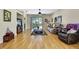 Open-concept living room with hardwood floors, a ceiling fan, and stylish furniture at 8149 Ambersweet Pl, Land O Lakes, FL 34637