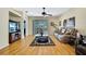 Spacious living room with hardwood floors, fan, and sliding glass doors at 8149 Ambersweet Pl, Land O Lakes, FL 34637