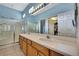 Main bathroom featuring dual sinks, walk-in shower, and large mirror at 8149 Ambersweet Pl, Land O Lakes, FL 34637