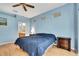 Bright main bedroom with light blue walls and wood floors; ensuite bathroom at 8149 Ambersweet Pl, Land O Lakes, FL 34637