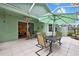 Enjoy outdoor dining on this screened patio with tiled floor and outdoor furniture at 8149 Ambersweet Pl, Land O Lakes, FL 34637