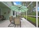 The covered patio features outdoor furniture for dining and relaxing outside at 8149 Ambersweet Pl, Land O Lakes, FL 34637