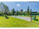 Shuffleboard courts offer a recreational space with mature landscaping and benches for players at 8149 Ambersweet Pl, Land O Lakes, FL 34637