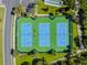 Aerial view of tennis courts with green and blue surface in a beautiful, well-maintained community at 8149 Ambersweet Pl, Land O Lakes, FL 34637
